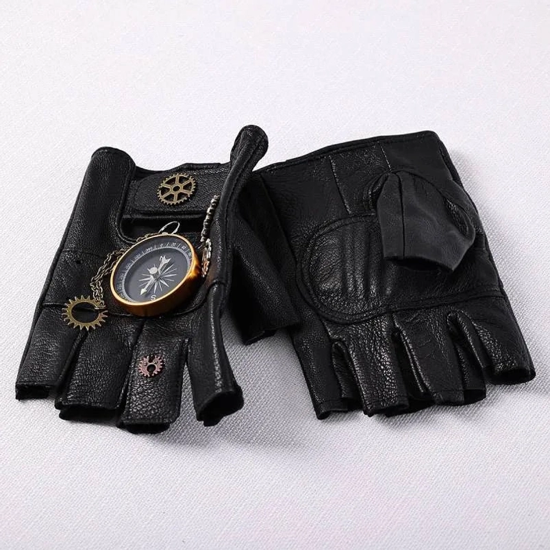 Pair of steampunk fingerless leather gloves flat lay showing one glove with compass and gear decoration and one plain black leather glove on white fabric background