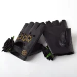 Black steampunk fingerless gloves with black fabric roses and vintage brass ornaments, flat lay on white background