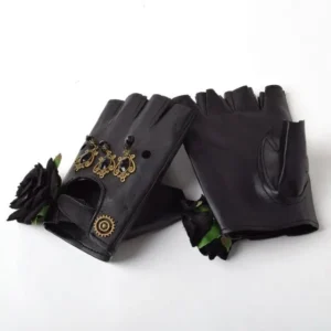 Black steampunk fingerless gloves with black fabric roses and vintage brass ornaments, flat lay on white background