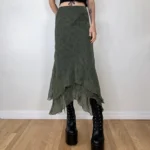 Olive green asymmetrical steampunk midi skirt with floral chiffon print worn by tattooed model in front view - high-waisted design with layered hem