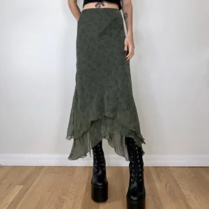 Olive green asymmetrical steampunk midi skirt with floral chiffon print worn by tattooed model in front view - high-waisted design with layered hem