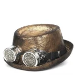 Steampunk gambler fedora hat with integrated removable goggles, distressed antique gold leather finish with weathered cracking detail, front facing studio view