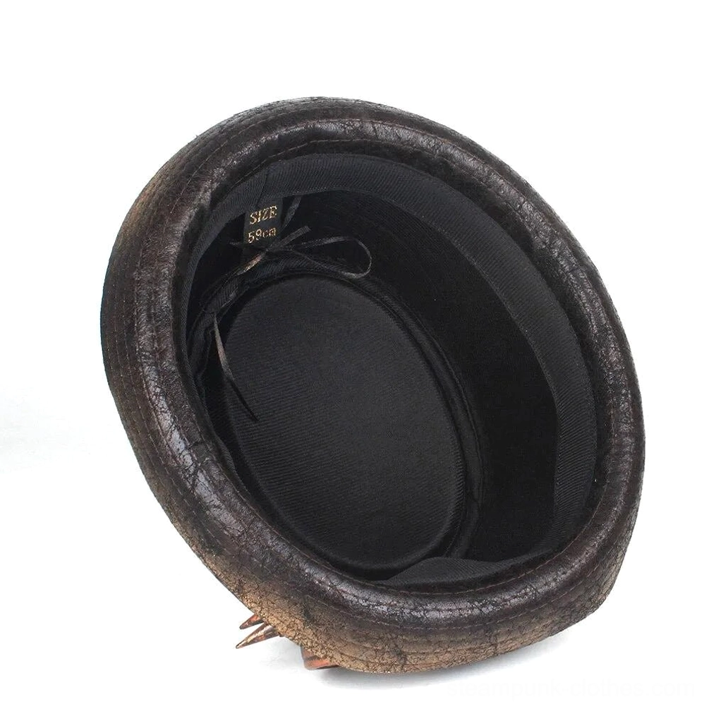 Interior view of steampunk gambler hat showing dark brown cracked brim, black inner lining with size tag, decorative spike trinkets, and removable goggles attachment points