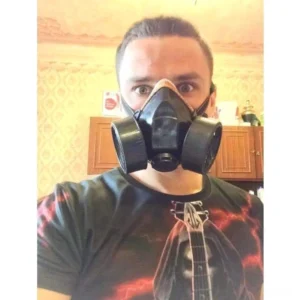 Adult male wearing industrial half-face steampunk gas mask indoors, demonstrating proper fit and authentic DieselPunk aesthetic