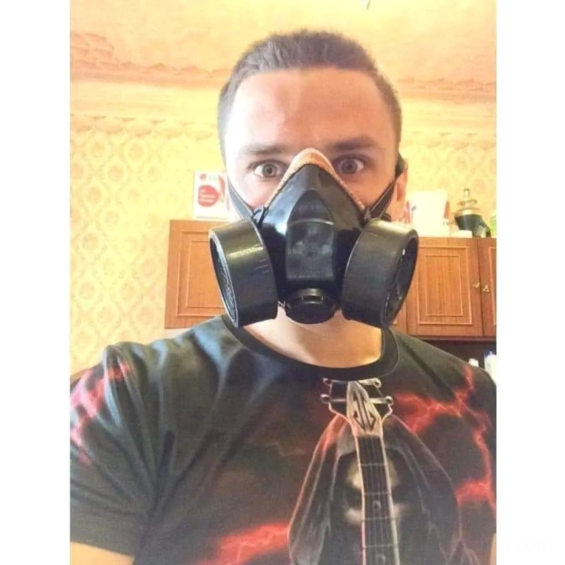 Adult male wearing industrial half-face steampunk gas mask indoors, demonstrating proper fit and authentic DieselPunk aesthetic