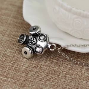 Steampunk gas mask necklace oblique angle showing three-dimensional filter tank design and dimensional mesh elements