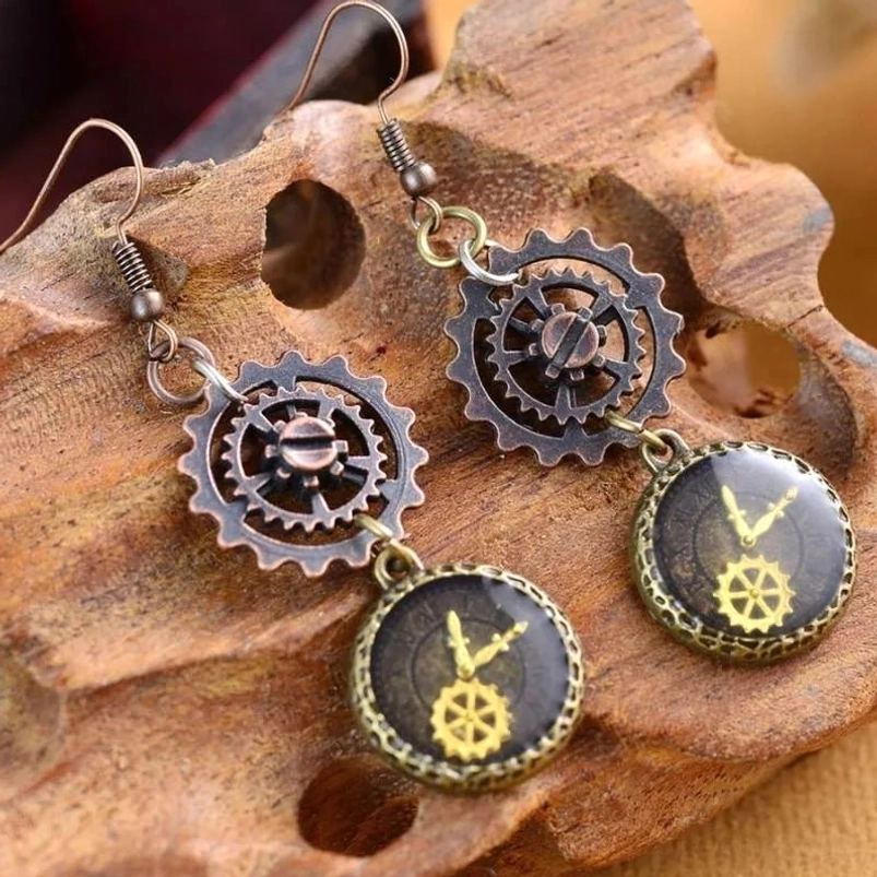 Steampunk gear drop earrings with antique bronze finish displayed on wooden stand, showing intricate clock and gear details