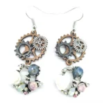 Steampunk gear drop earrings with vintage metal gears, hand-crafted resin roses, and colored gemstones - front flat view