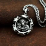 Men's steampunk gear pendant necklace with hollow exposed gears and spiked circular frame, vintage silver-toned 316L stainless steel finish, displayed on dark brown leather background