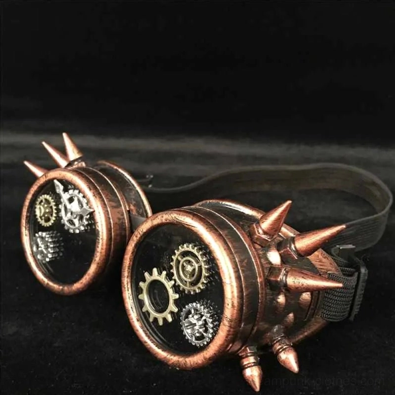Steampunk gear-spiked goggles with bronze metal frame and mechanical details, flat lay view