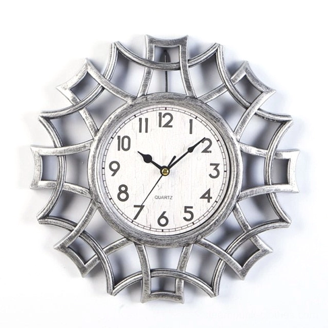 Brushed silver steampunk geometric wall clock with vintage quartz dial and precision-cut web pattern frame isolated on white background