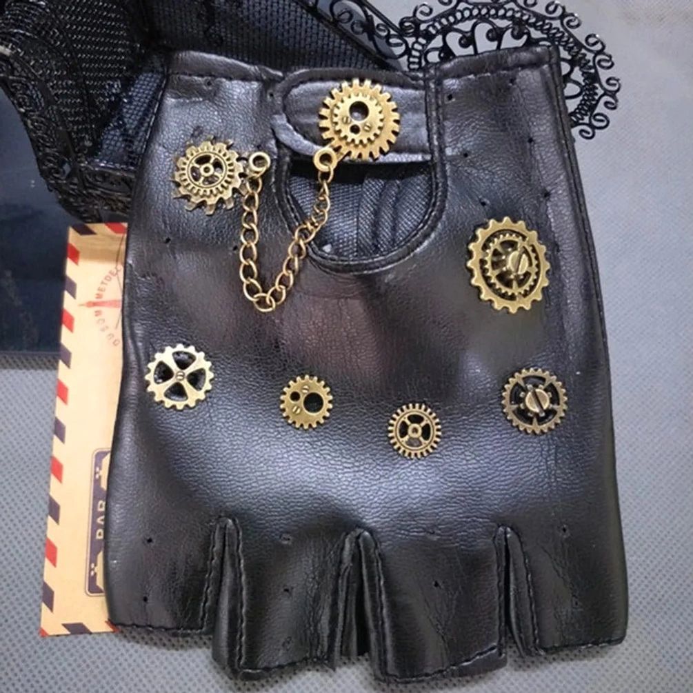 Flat lay close-up of black steampunk fingerless glove featuring multiple bronze gear charms and decorative metal chain accent