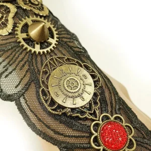 Close-up overhead view of steampunk glove details including gear decorations, spike accents, red floral gem, and mesh lace construction