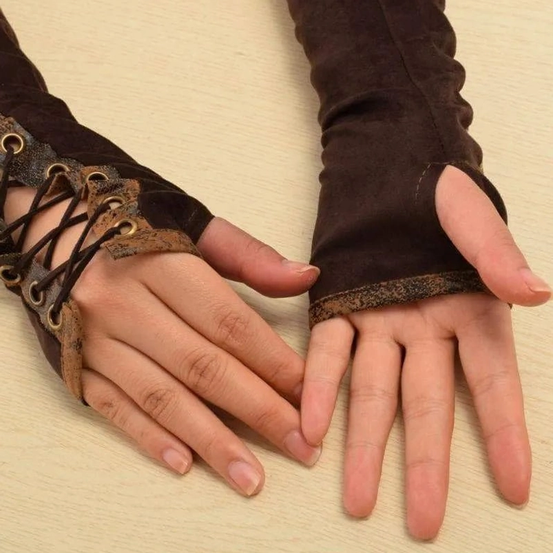 Close-up side view of brown steampunk fingerless arm gloves on human hands showing lace fasteners, suede material and cuff construction