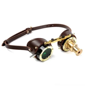 Steampunk goggles with brown leather strap and brass hardware, three-quarter front view showcasing mixed functional lenses and metal frame details