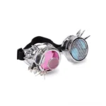 Steampunk goggles with pink and blue dual-color lenses, silver plastic frame, decorative spike trim, shot from three-quarter left front view