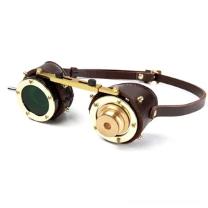 Dark green round lens steampunk goggles with gold-toned brass hardware and adjustable dark leather head strap, direct front view
