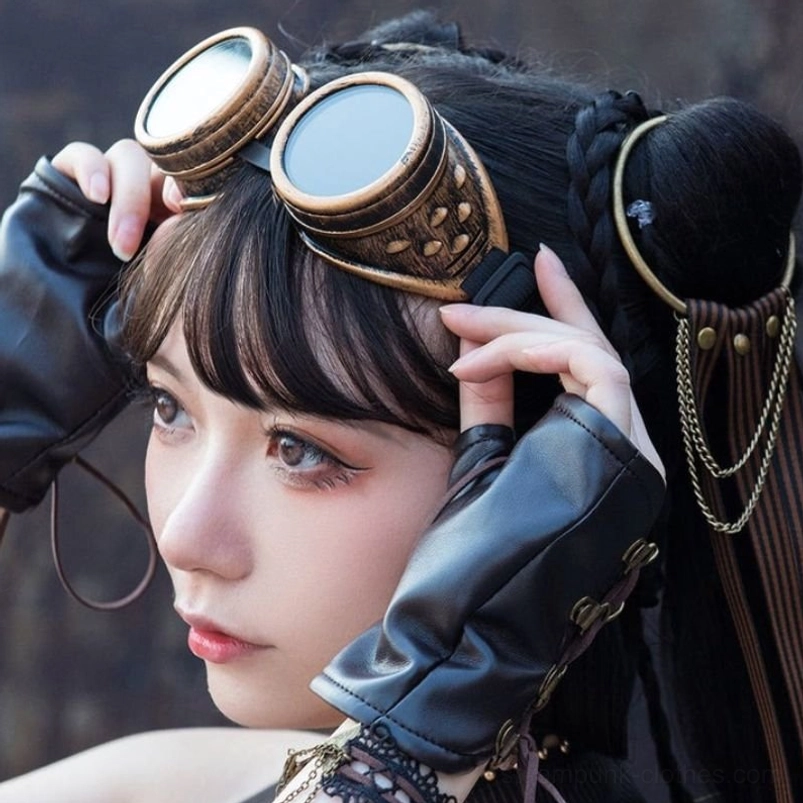 Close-up side view of steampunk cosplay goggles with bronze gold finish paired with leather gloves