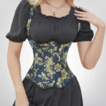 Victorian steampunk underbust corset with gold brocade floral pattern and puff sleeve peasant blouse, front view demonstrating elegant waist cinching and décolletage enhancement