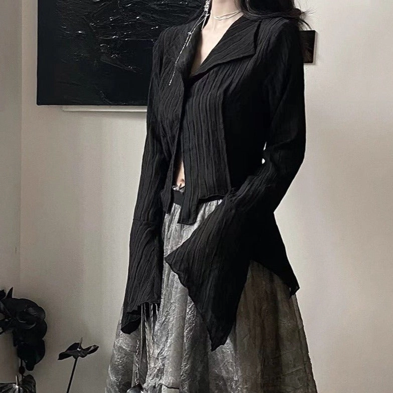 Black gothic steampunk long-sleeve blouse with wide lapels and unbuttoned placket, paired with silver metallic skirt - editorial styling shot