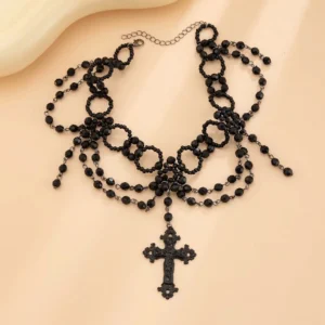 Steampunk gothic cross choker flat lay display showing multi-layer black beaded structure with extension chain and carved cross pendant