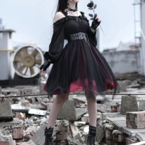 Full-body view of gothic off-shoulder steampunk lolita dress with layered black and red tulle, dramatic puff sleeves, and decorative chain waist belt on female model in industrial abandoned rooftop setting
