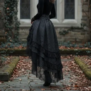 Back view of black steampunk gothic lolita skirt with flowing layered lace ruffles and sheer hem details against ivy-covered building backdrop