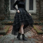 Black high-low asymmetrical ruffle steampunk gothic lolita skirt worn by model in autumn courtyard setting, featuring layered lace hem and structured silhouette