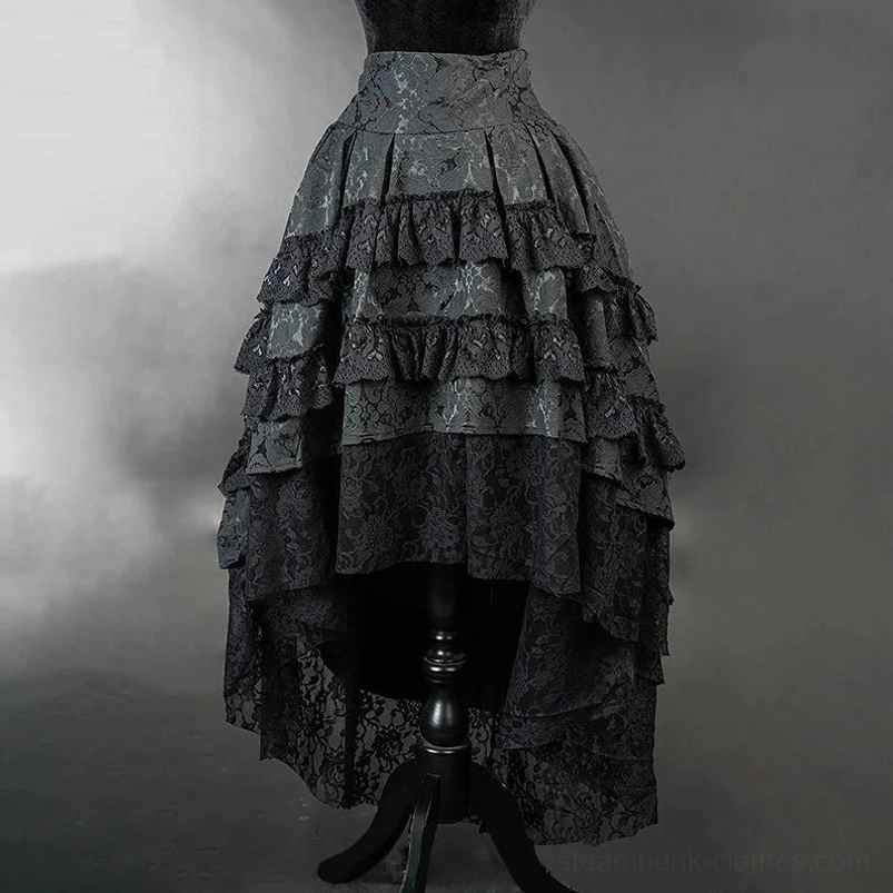 Side angle view of black steampunk gothic lolita skirt showing asymmetrical hemline, layered ruffles, and silhouette profile with studio backdrop