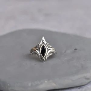 Gothic steampunk silver ring flat lay front view displaying ornate scroll engravings, polished silver metal finish, and black onyx center stone