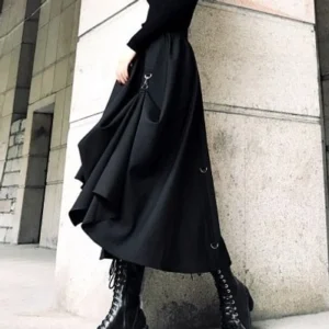 Black high-low gothic utility skirt with draped matte fabric and metal decorative hardware, side profile view