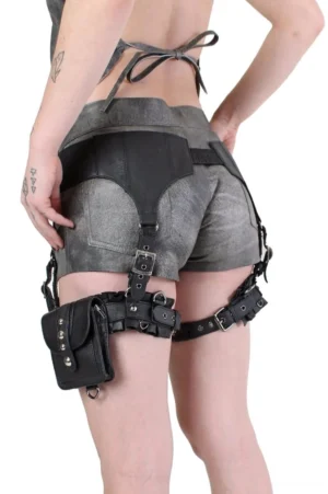 Steampunk gothic thigh holster rig rear perspective displaying dual adjustable leg straps, metal hardware, and studded industrial detailing on model