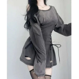Steampunk grunge mini dress side three-quarter view, model wearing black thigh-high stockings, distressed washed finish with functional side lacing detail visible