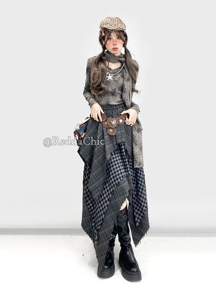 Full front view of asymmetrical plaid steampunk gypsy skirt with longer hem, styled with knit beret, neck gaiter, and platform leather boots