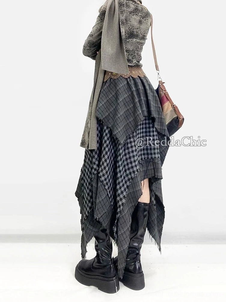 Asymmetrical patchwork plaid skirt from behind, paired with wide brown leather waist belt and vintage crossbody shoulder bag