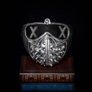 steampunk spiked half mask with silver finish and x mesh eye covers displayed on vintage book stack industrial aesthetic