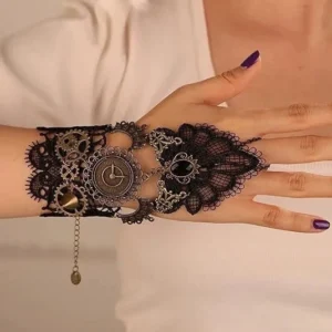 Steampunk wrist hand lace accessory with vintage metal parts and dangling chain, front close-up flat lay on white background, purple nail polish detail