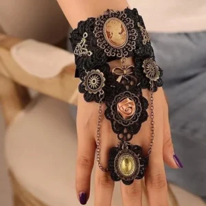 Steampunk hand slave bracelet side profile showing black lace, bronze metal charms, and hanging chain pendant on female model