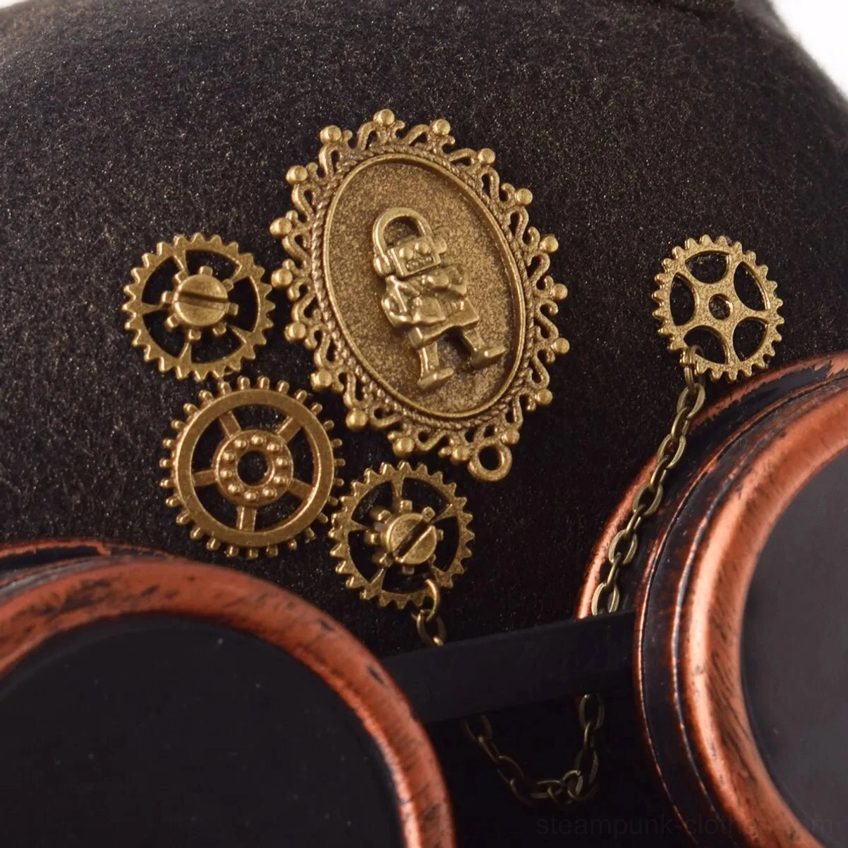 Front close-up detail of steampunk bowler hat showing brass gear charms and cameo medallion