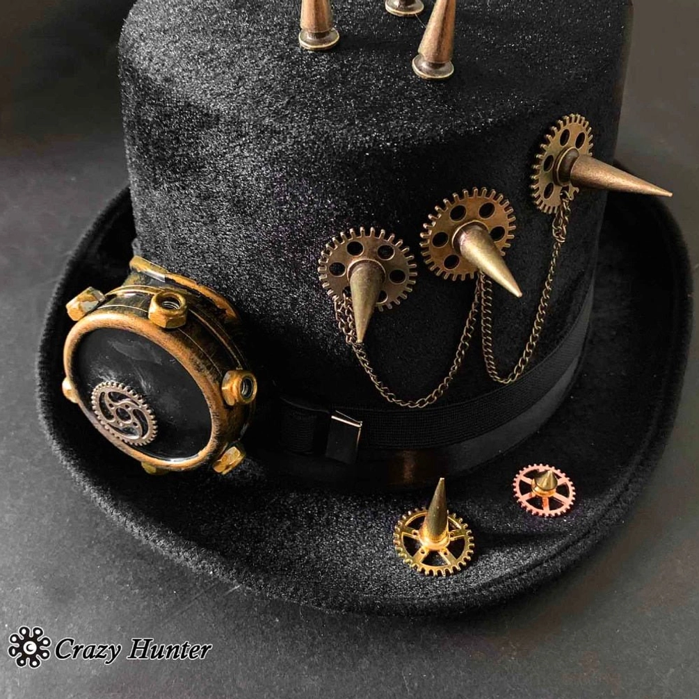 Close-up detail of steampunk top hat showing black velvet texture, multiple metal spikes, brass gears, chain accents and gear pins