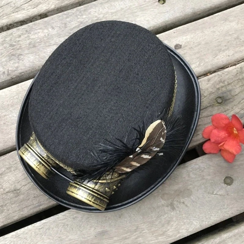 Overhead top-down view of steampunk top hat with brass goggles, striped feather decoration, complete ensemble aesthetic