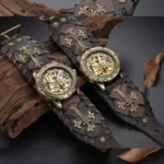 Steampunk hollow mechanical wristwatch with exposed bronze skeleton movement and cross-pattern dark brown leather strap, shot in overhead view against weathered wood and dry leaves