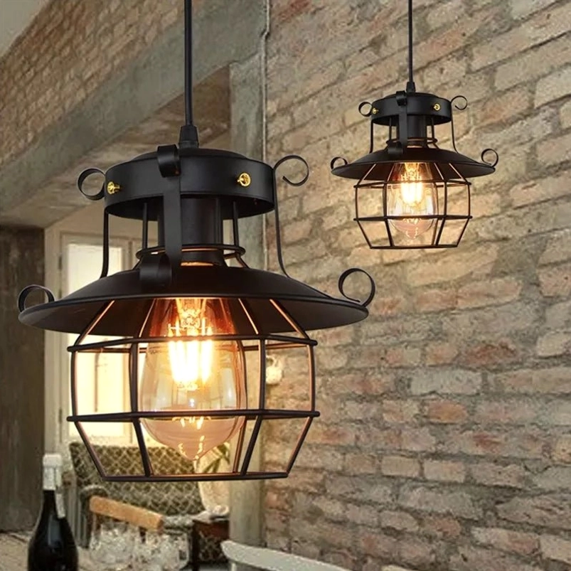 Steampunk industrial hanging cage light fixture with warm glowing exposed bulb installed in retro brick wall dining area, eye-level ambient view