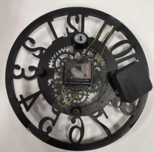 Rear view of vintage steampunk wall clock showing matte black finish, exposed quartz movement mechanism, battery compartment, and wall mounting holes