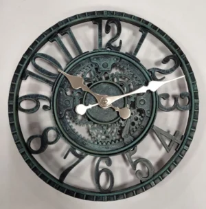 Steampunk industrial wall clock with verdigris patina, hollowed Arabic numerals, exposed gear movement, and metallic hands on white background