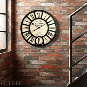 Industrial steampunk wall clock side view mounted on brick wall, showing aged weathered finish, sub-dial detail, and authentic vintage patina aesthetic