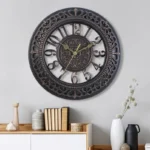Steampunk industrial wall clock with dark bronze hollow-carved frame, 3D Arabic numerals, and retro embossed dial center displayed in modern home living room