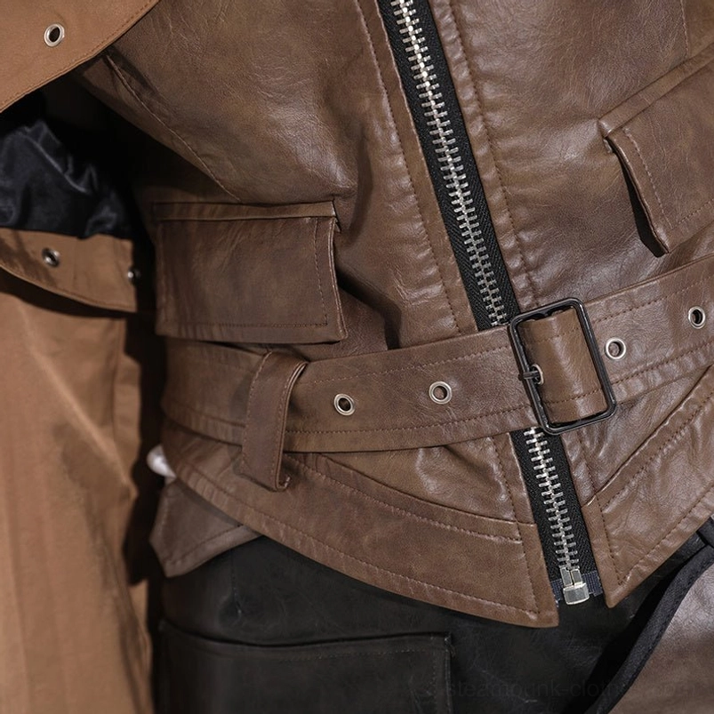 Front detail view of steampunk cropped jacket showing dark brown PU leather, waist buckle belt, functional flap pockets, and center metal zipper closure
