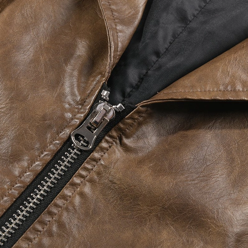 Close-up detail of vintage-style silver metal zipper on brown faux leather steampunk jacket with black microfiber lining visible