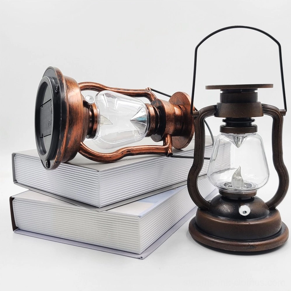 Overhead view of two retro LED steampunk kerosene lanterns with one laying on side showing bronze weathered metal